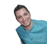 a man in a blue shirt smiling for the camera